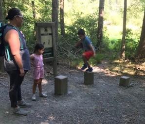 Children hopping on logs