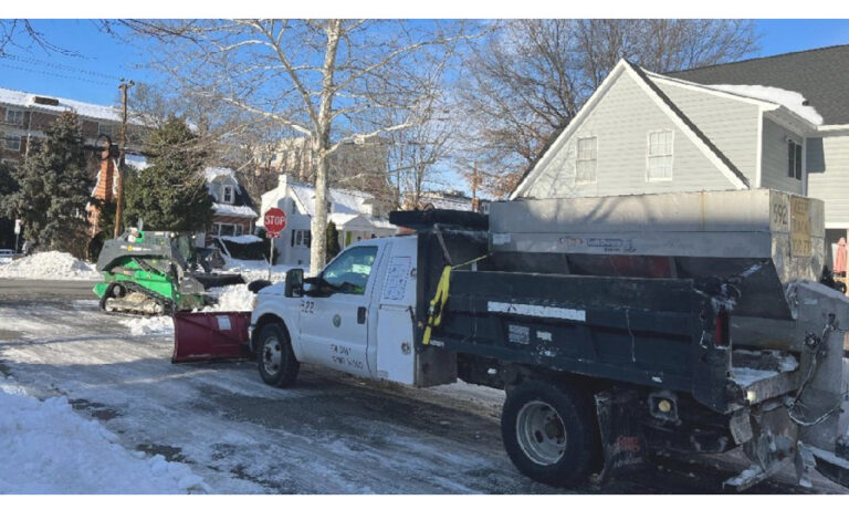 Snowplow and front loader working to clear snow