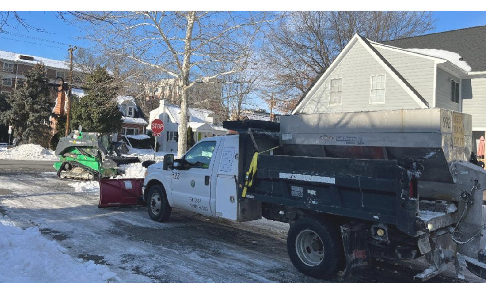 Snowplow and front loader working to clear snow